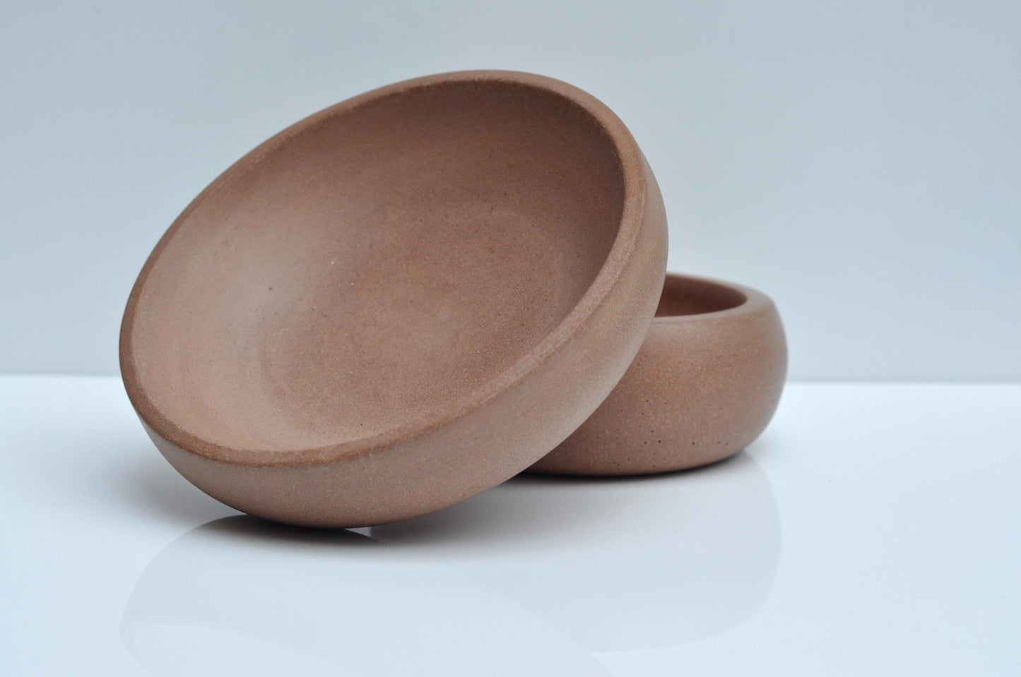 Small shallow orange cement dish