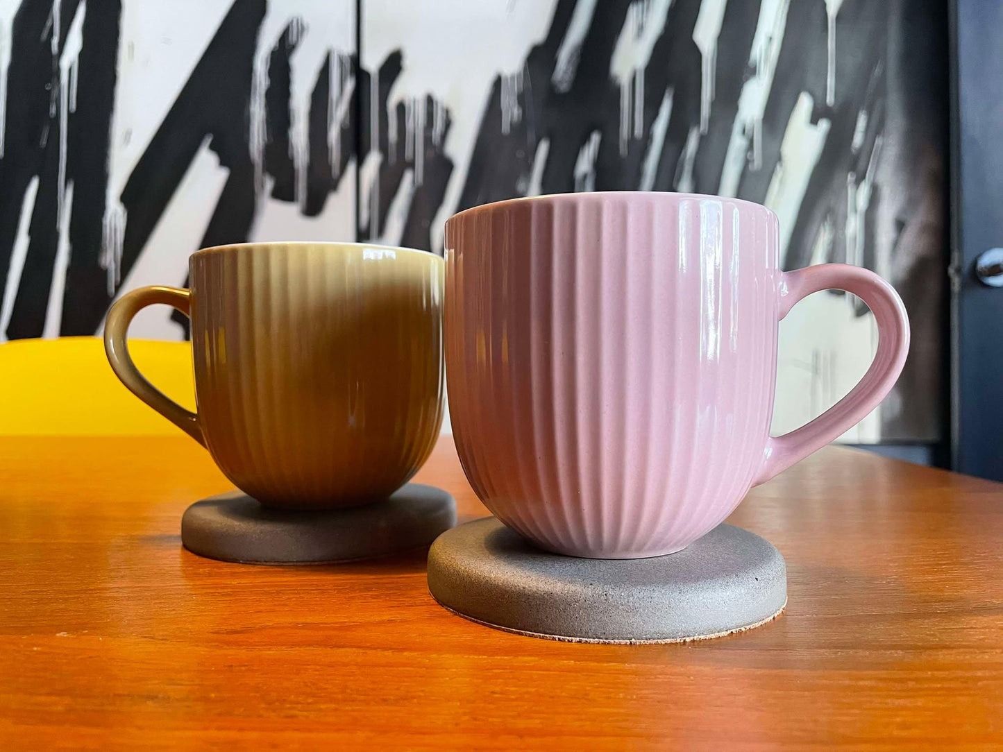 Concrete drink coasters set styled with cup