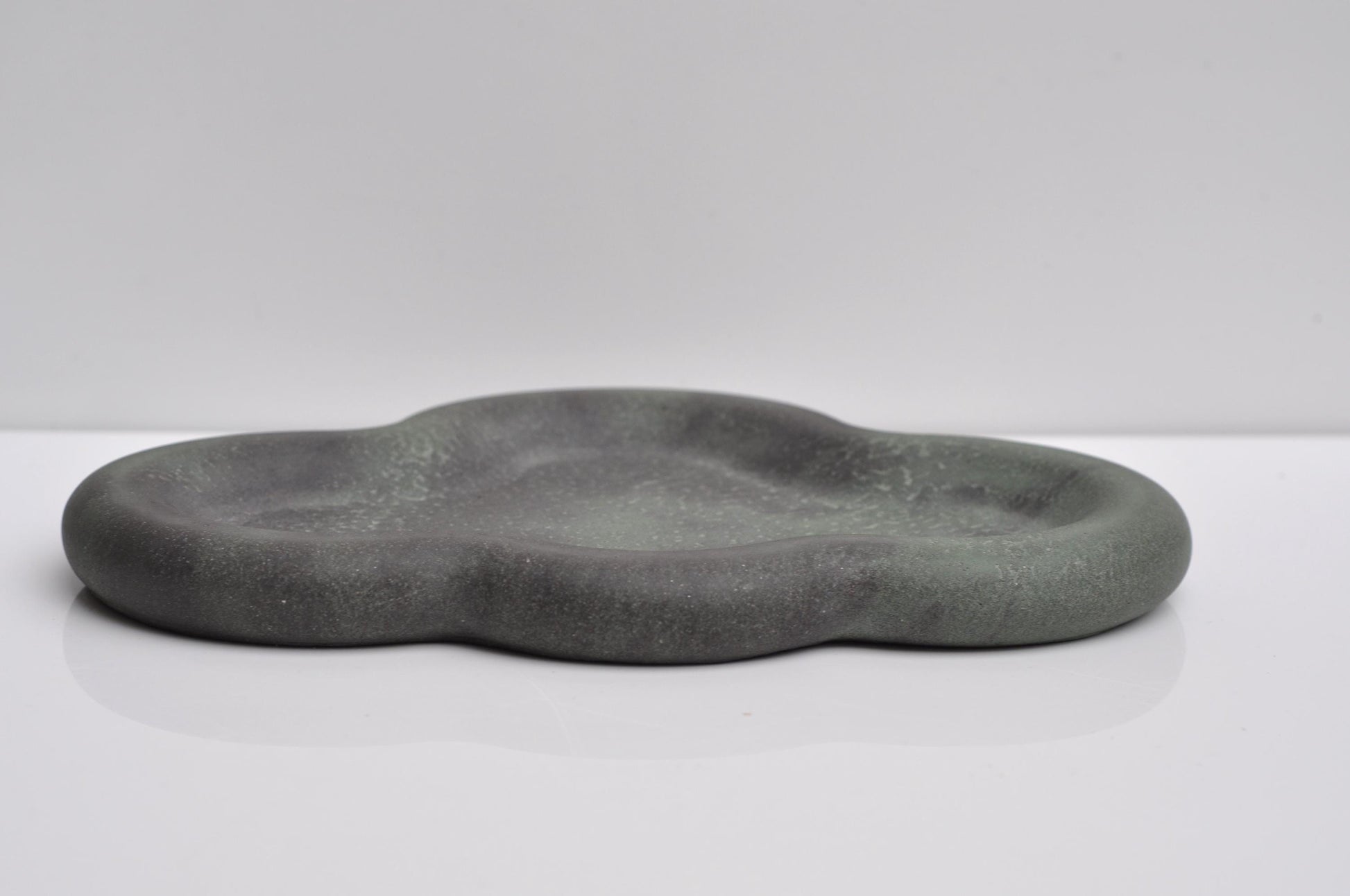 Close-up showing texture of grey and green concrete