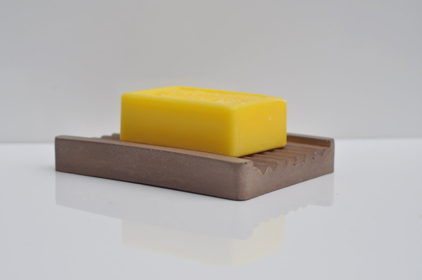 Brown cement soap tray on countertop