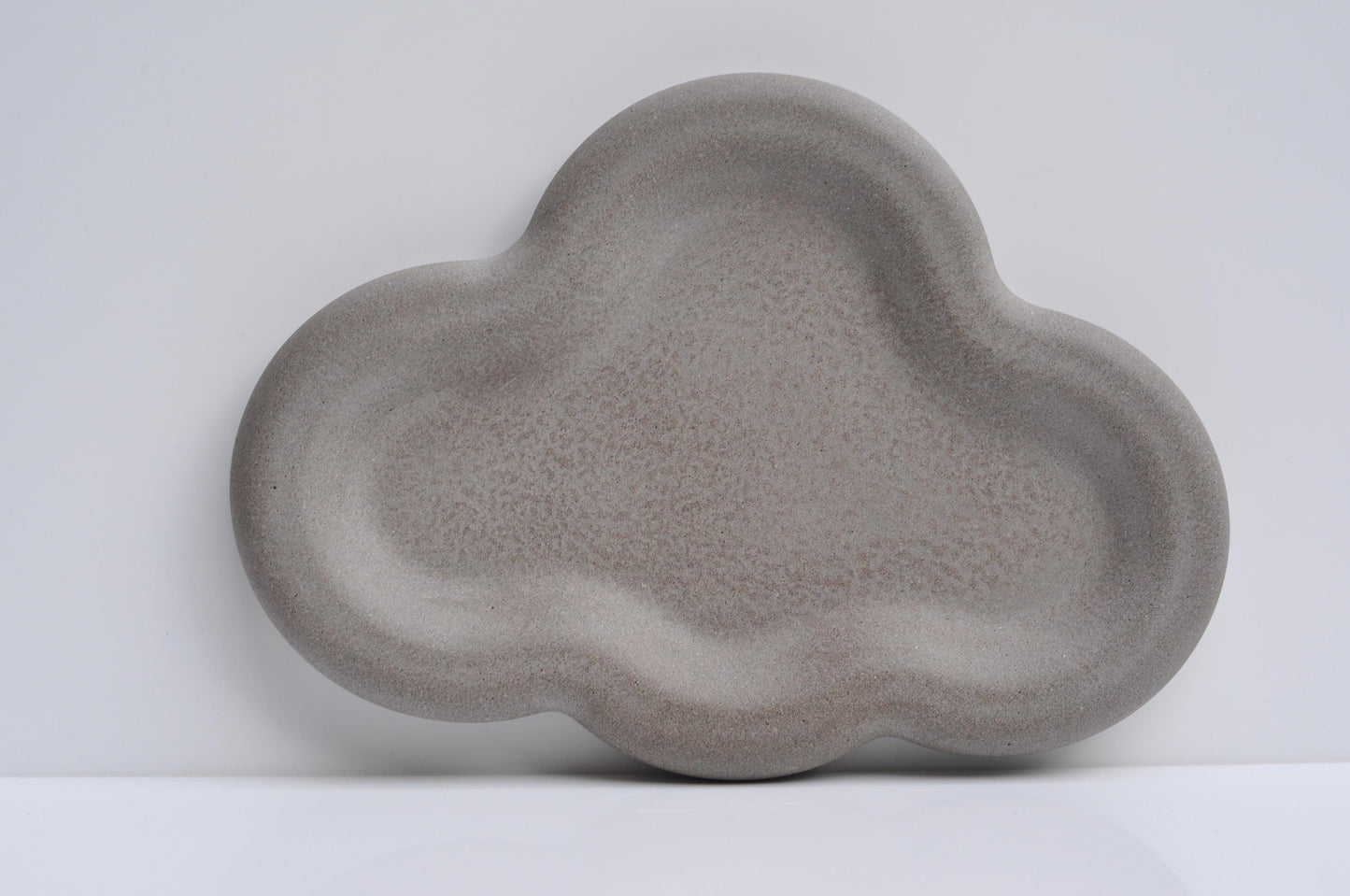 Modern decorative concrete tray on a wooden table