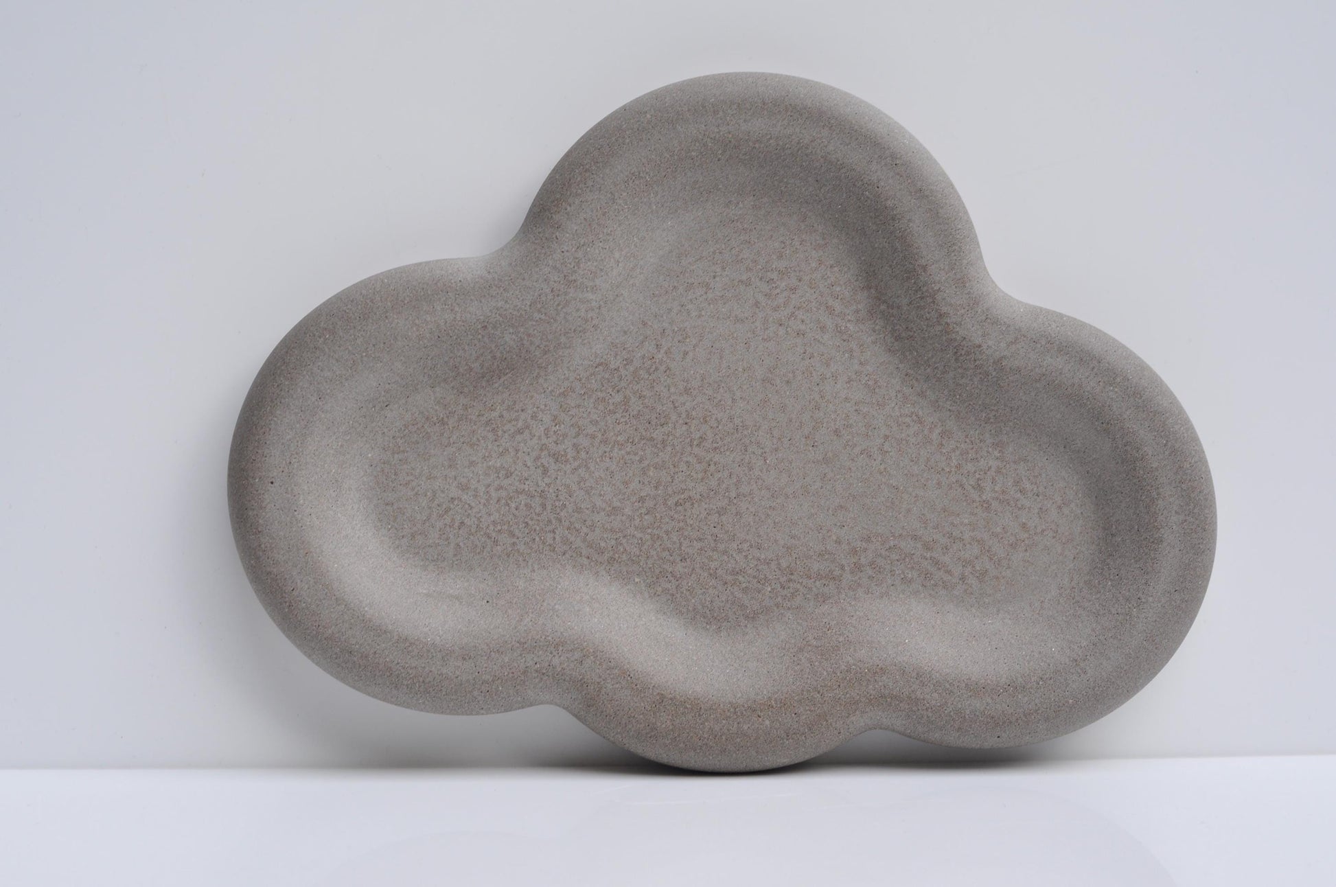 Modern decorative concrete tray on a wooden table