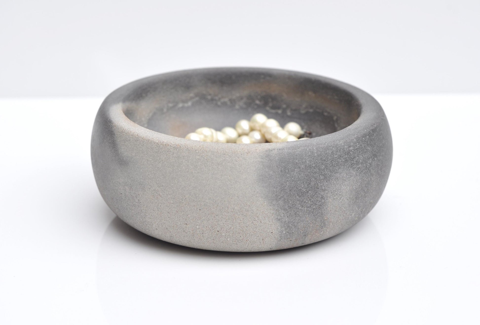 Close-up texture of handmade grey concrete bowl