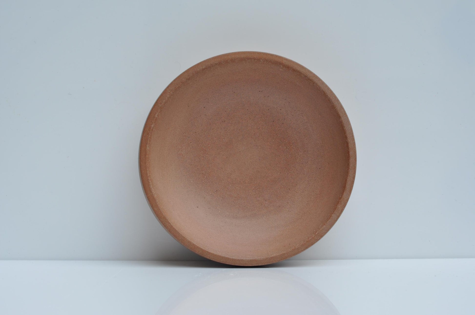 Modern concrete bowl against plain background