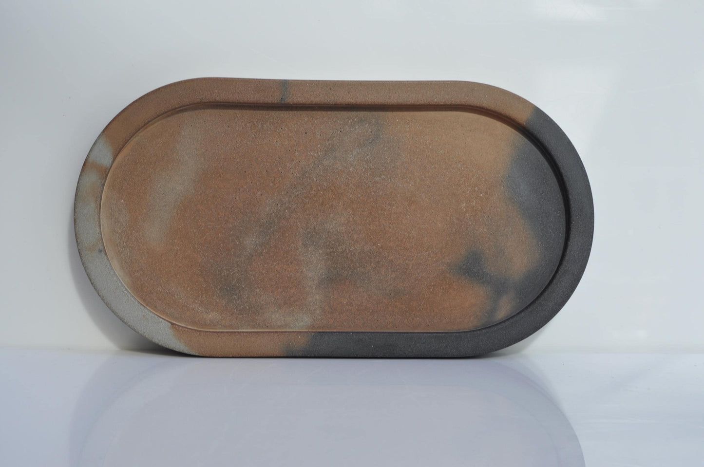 Rectangular concrete tray with a brownish-red surface on a white background