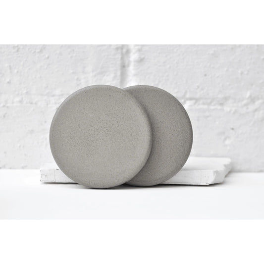 Handmade concrete coasters set of two displayed on table