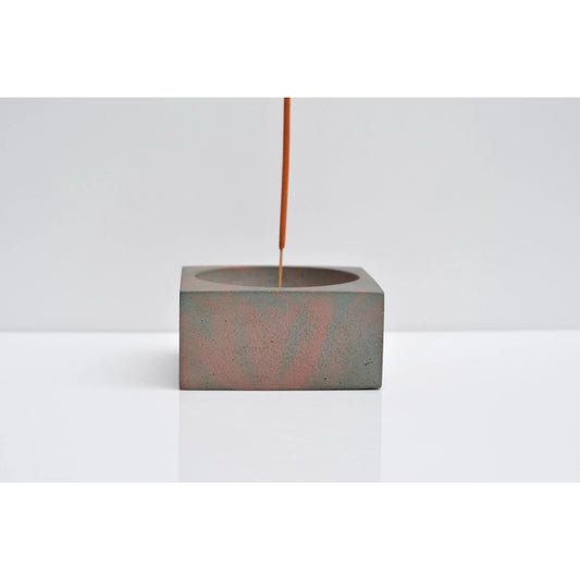 Side view of minimalist concrete incense holder