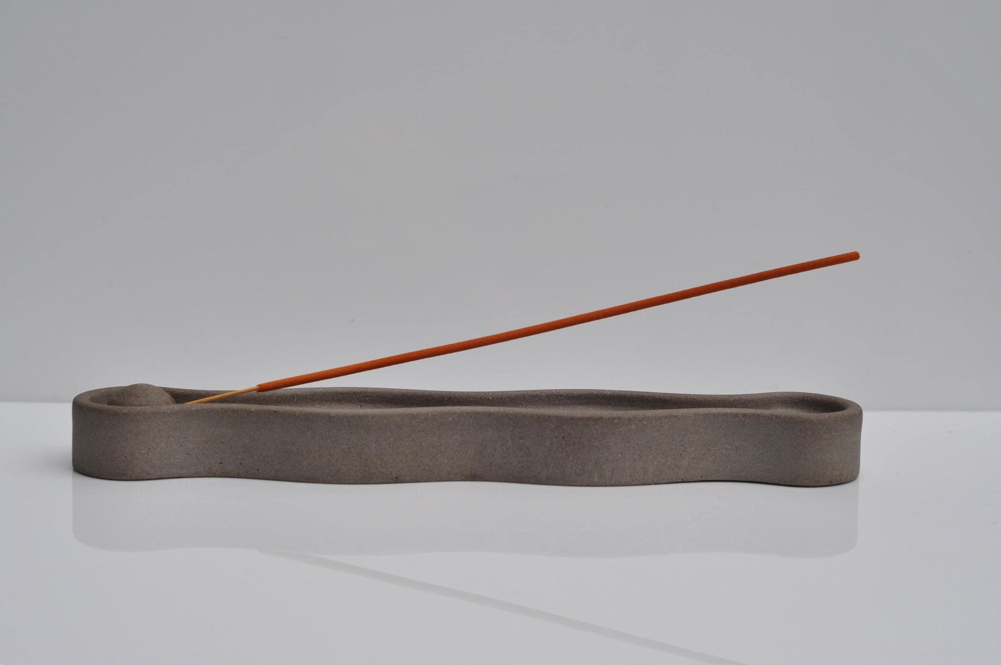 Minimal incense burner on neutral background