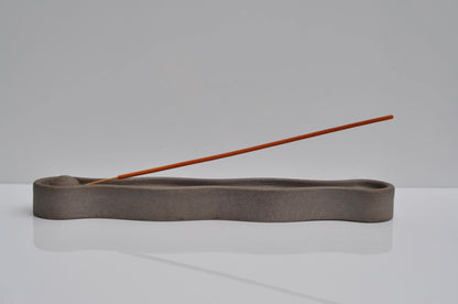 Minimal incense burner on neutral background