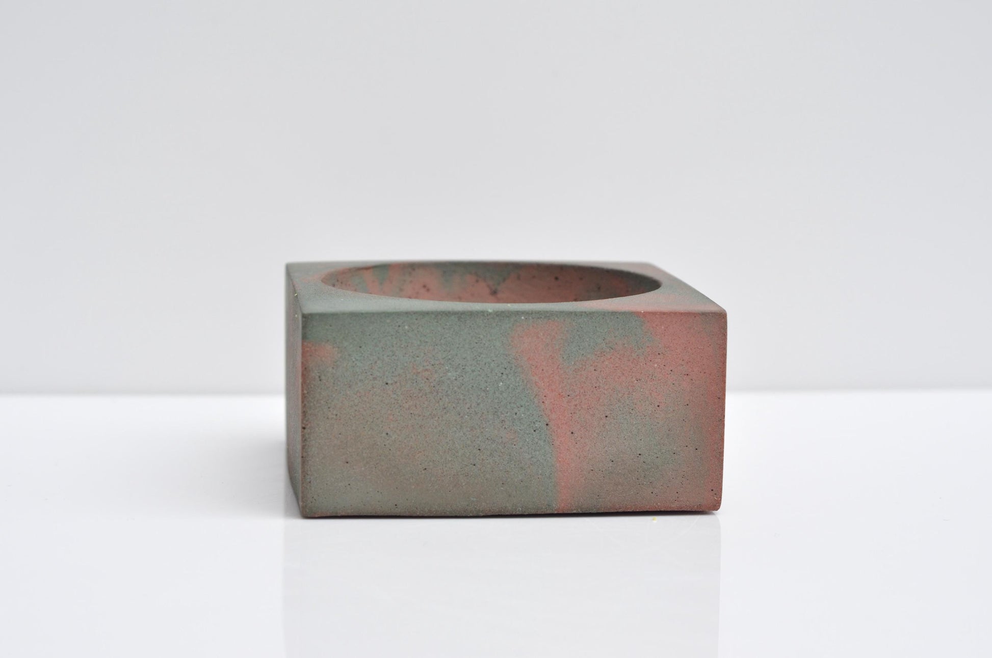 Concrete incense burner on wooden table