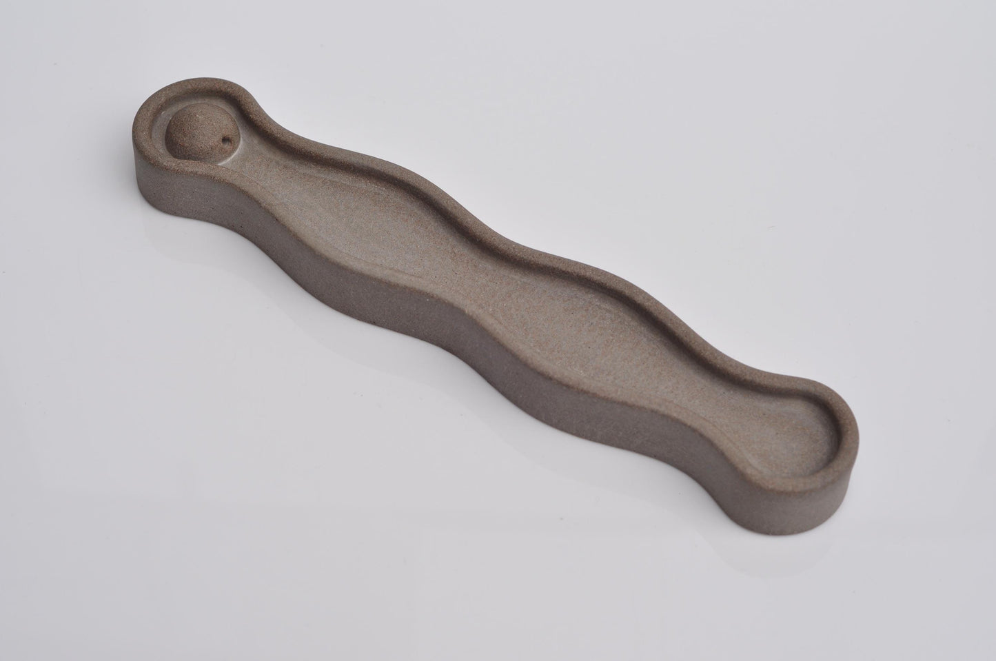 Side angle of modern concrete incense tray