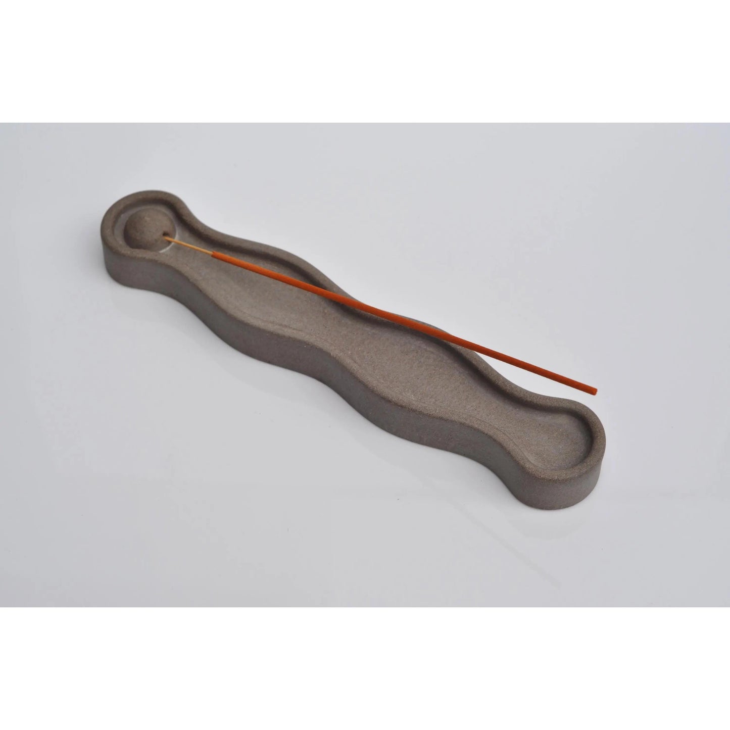 Handmade concrete incense burner holding joss stick