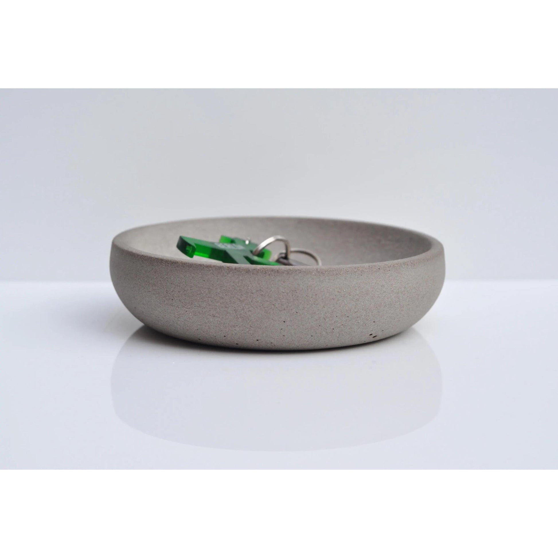 Handmade concrete key and coin bowl on entryway table