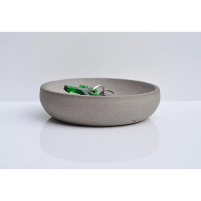 Handmade concrete key and coin bowl on entryway table