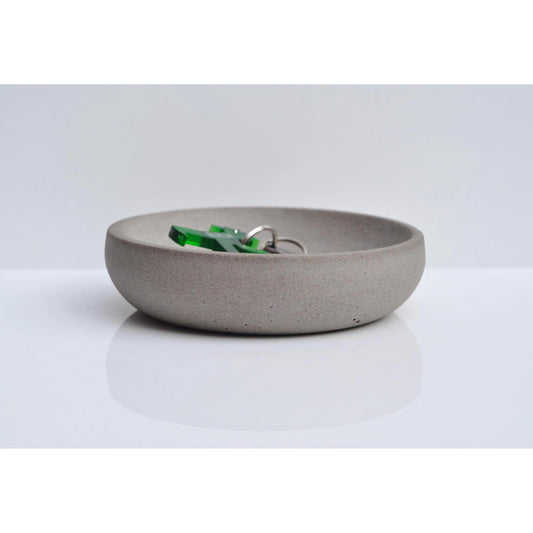 Handmade concrete key and coin bowl on entryway table