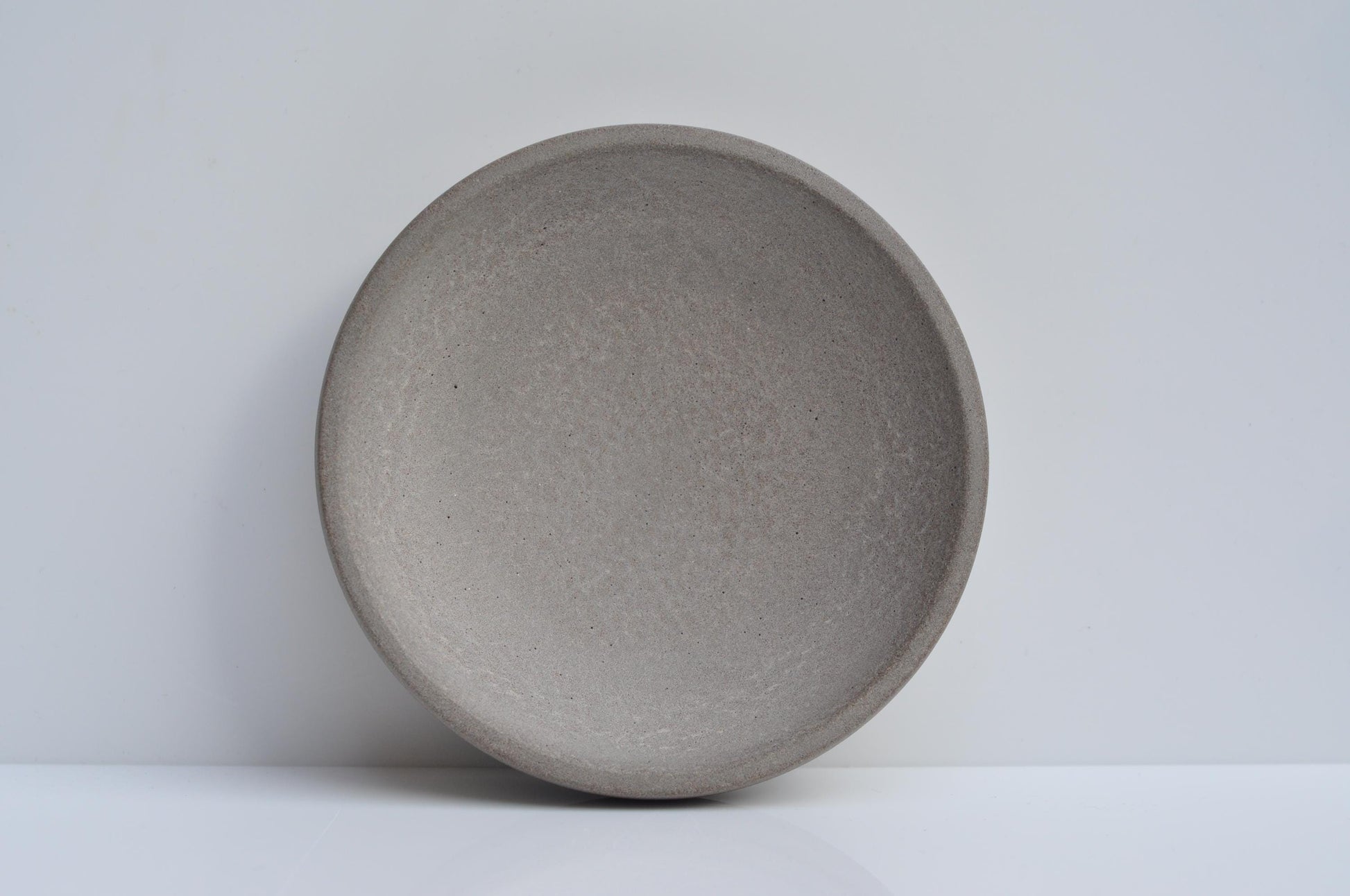 Studio shot of handmade concrete key and coin bowl