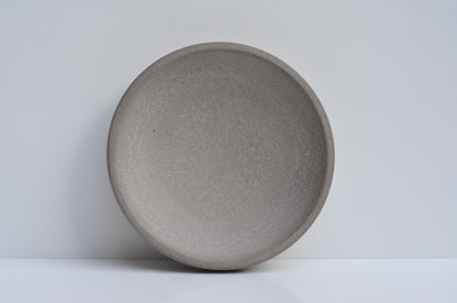 Studio shot of handmade concrete key and coin bowl