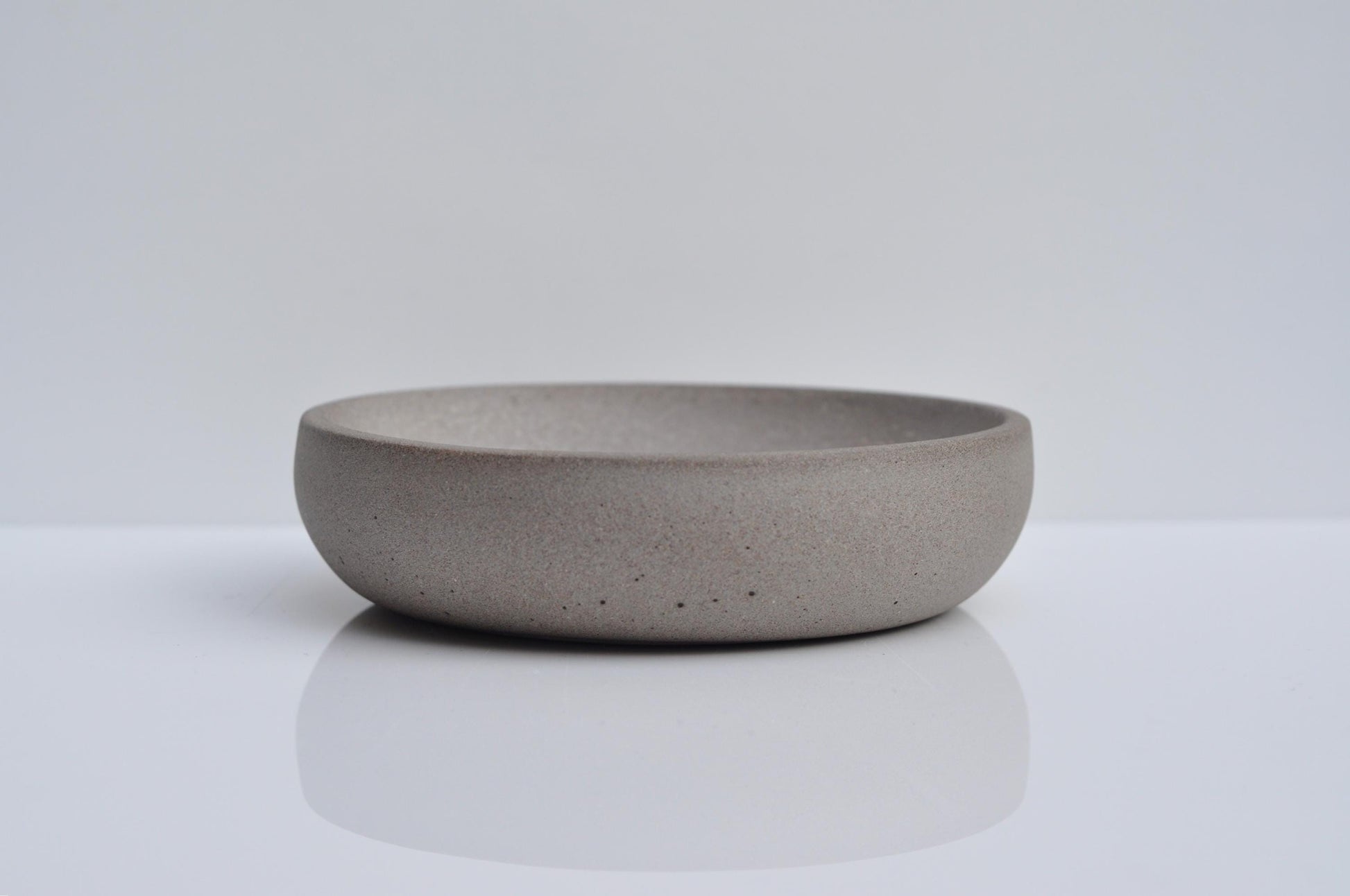 Side angle of small concrete dish for keys and coins