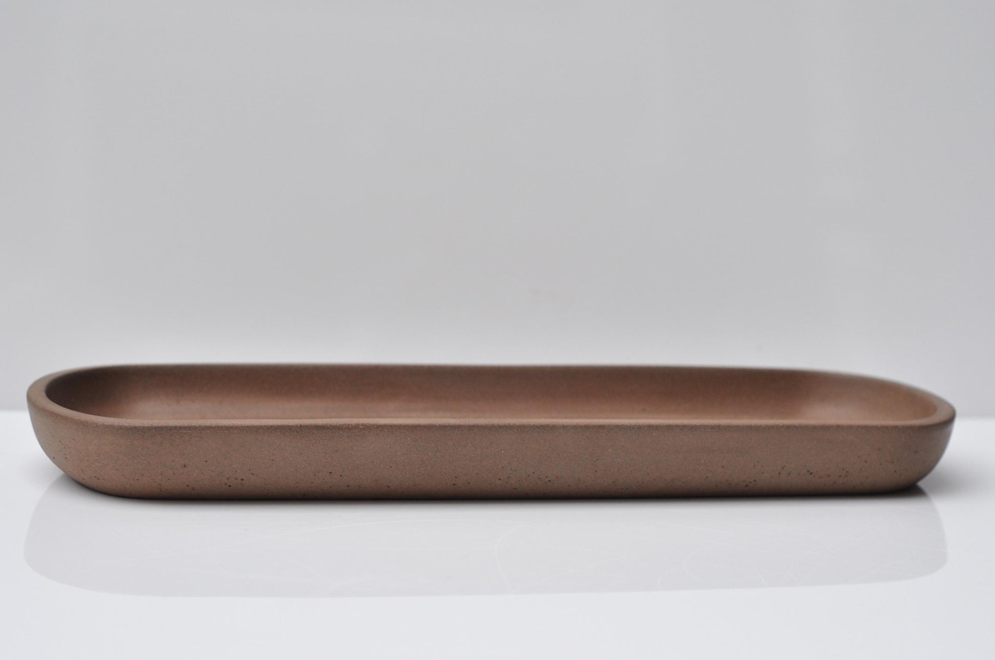 Modern orange concrete dish styled with decor items