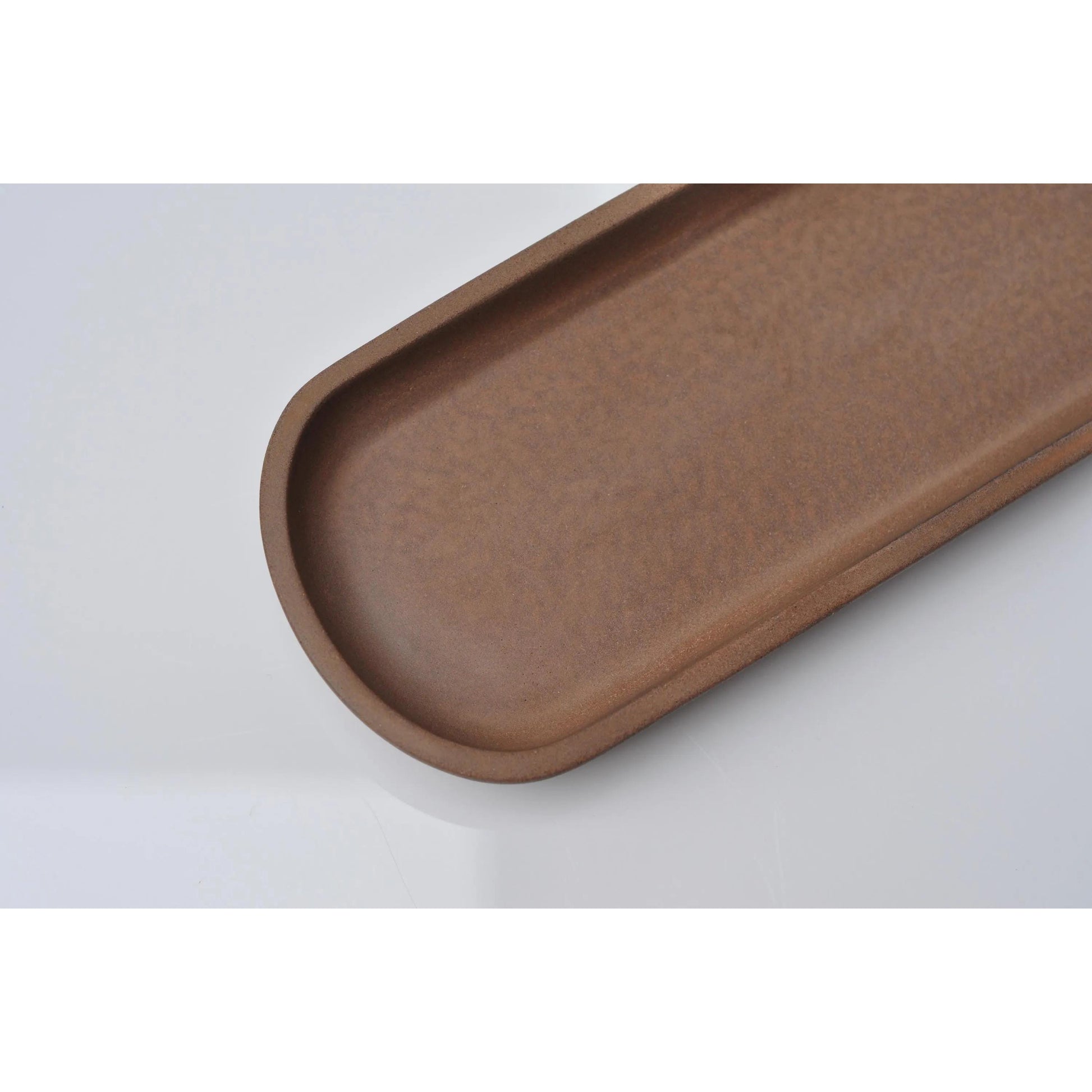 Handmade orange oblong concrete tray with smooth finish