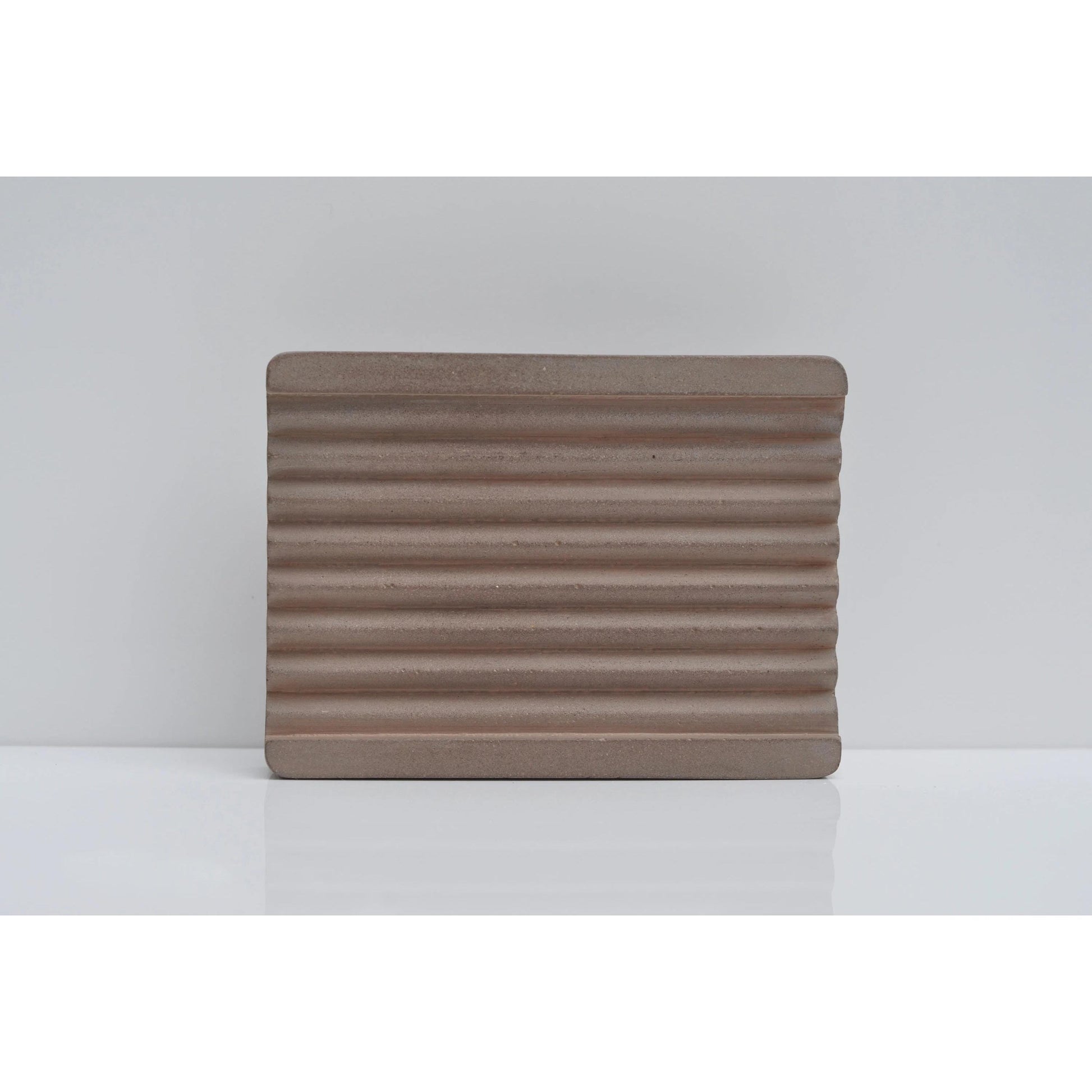 Brown cement soap tray on countertop