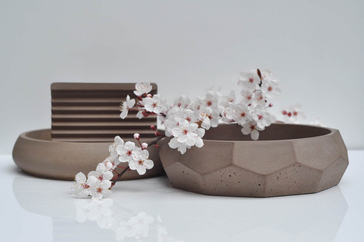 Modern soap holder made of brown concrete and bowls