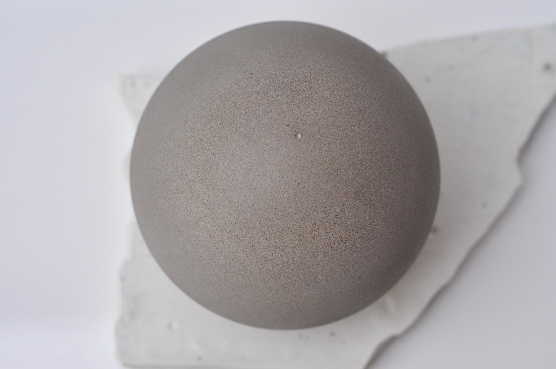 Handmade grey concrete sphere decor close-up