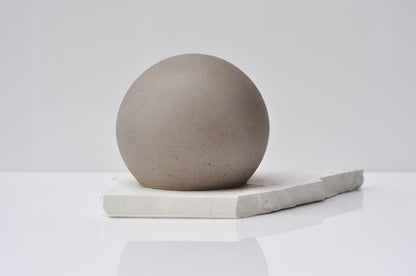 Smooth grey concrete sphere decorative accent