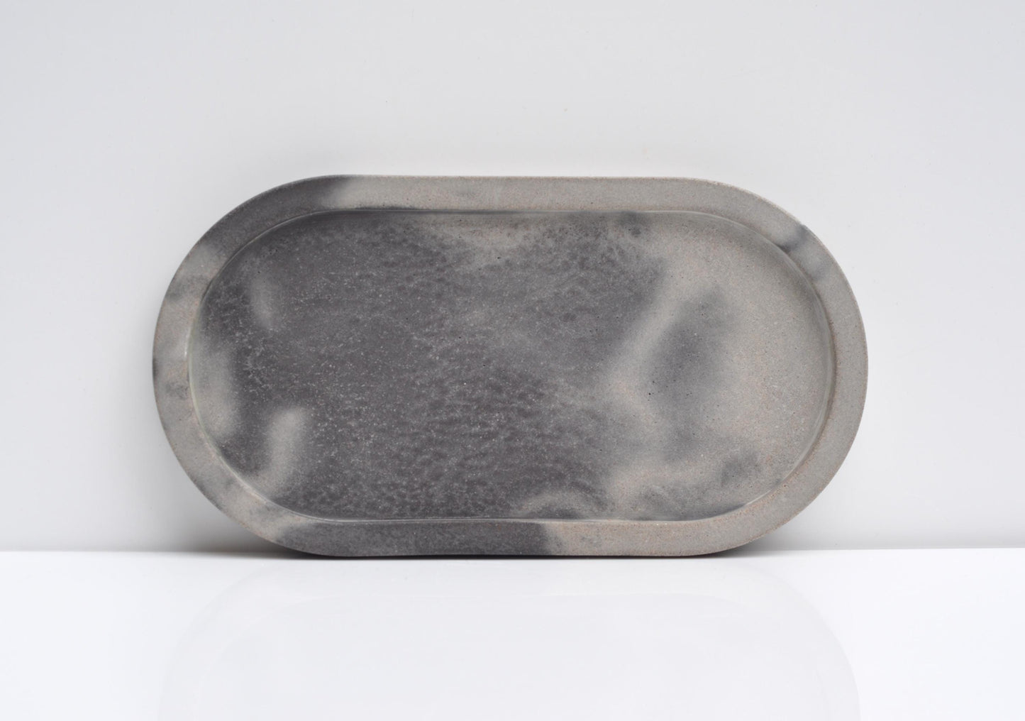 Studio shot of oval handmade concrete candle tray