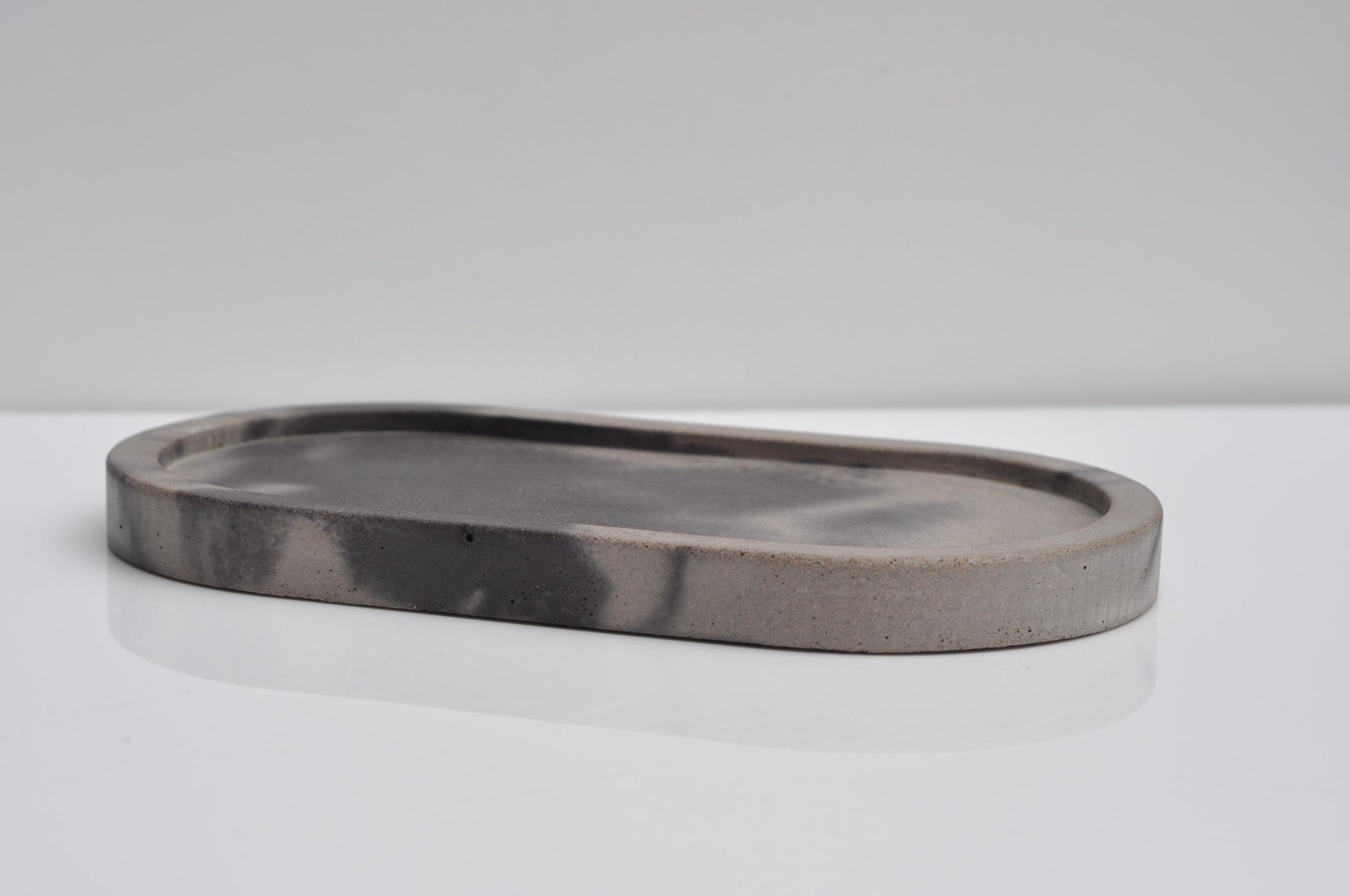 Decorative oval concrete tray on shelf