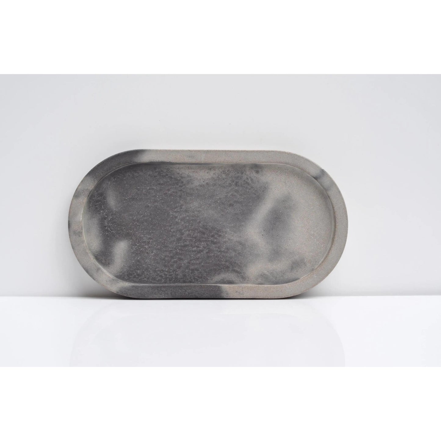 Side view of handmade oval concrete tray