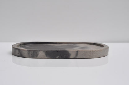 Minimalist oval concrete tray styled in modern home