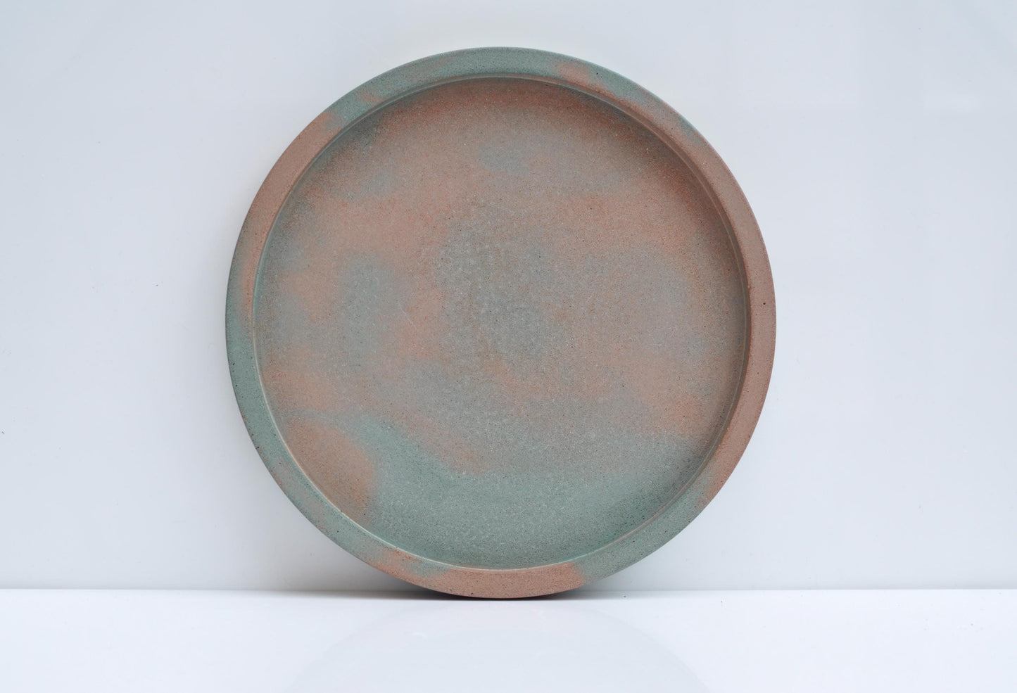 Studio shot of handmade orange and green concrete tray