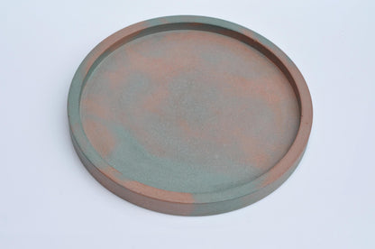 Minimalist round concrete tray styled on shelf