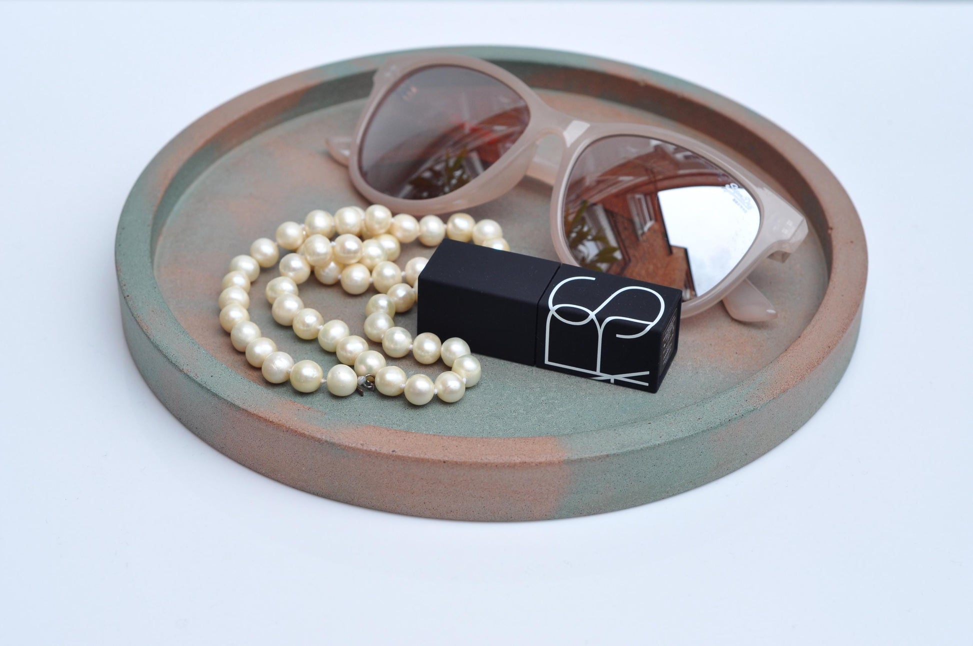 Studio shot of handmade orange and green concrete tray