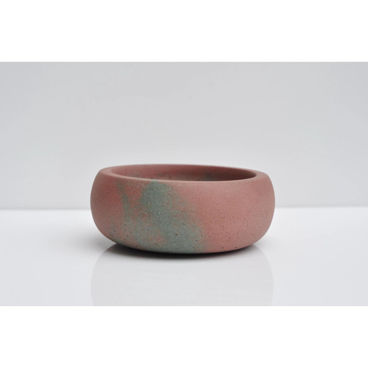 Side view of handmade pink and green concrete jewellery bowl