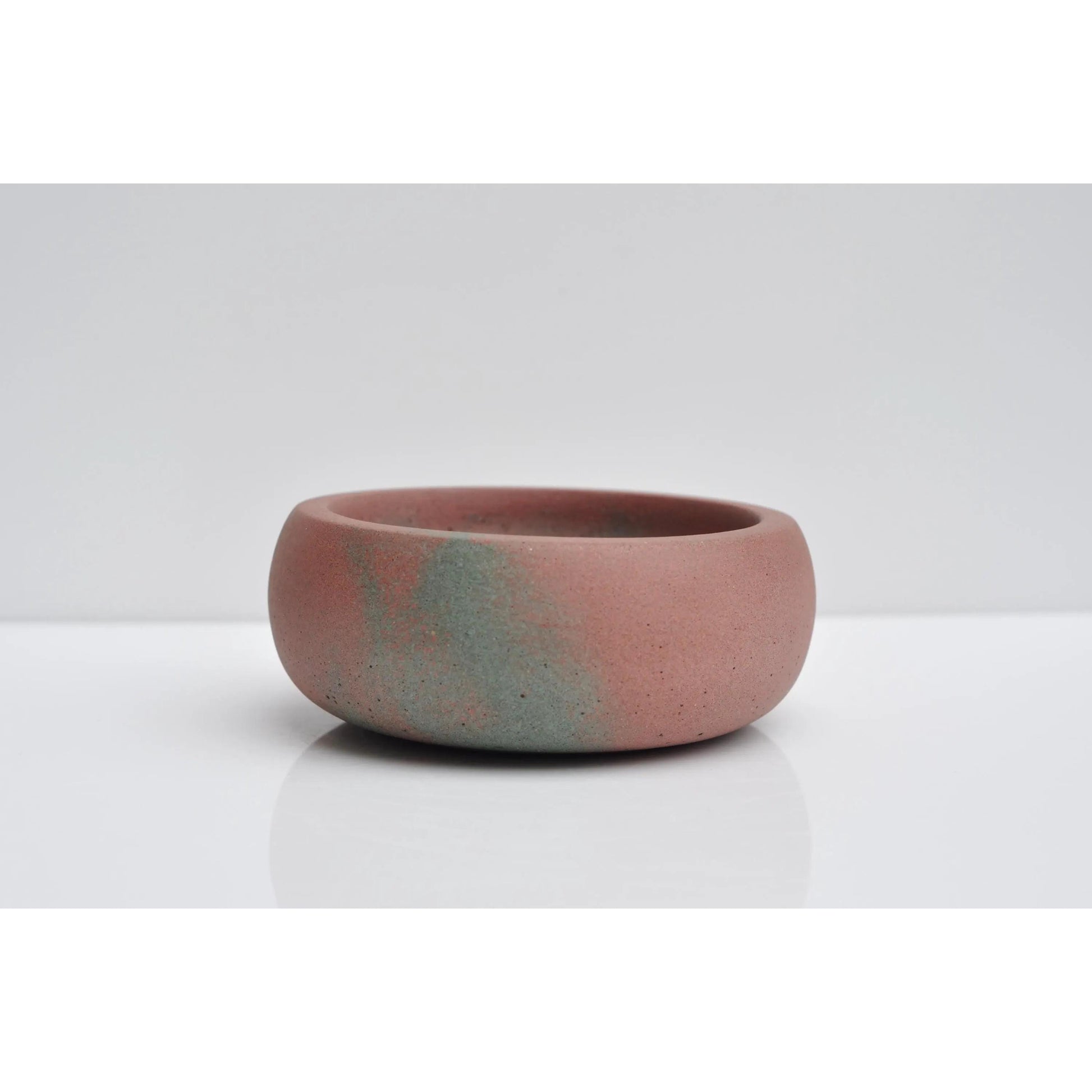 Side view of handmade pink and green concrete jewellery bowl