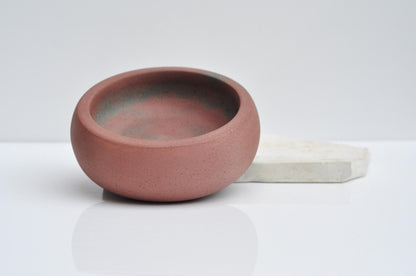 Minimalist concrete trinket dish styled on shelf