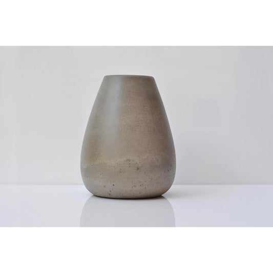 Large grey concrete vase on wooden shelf