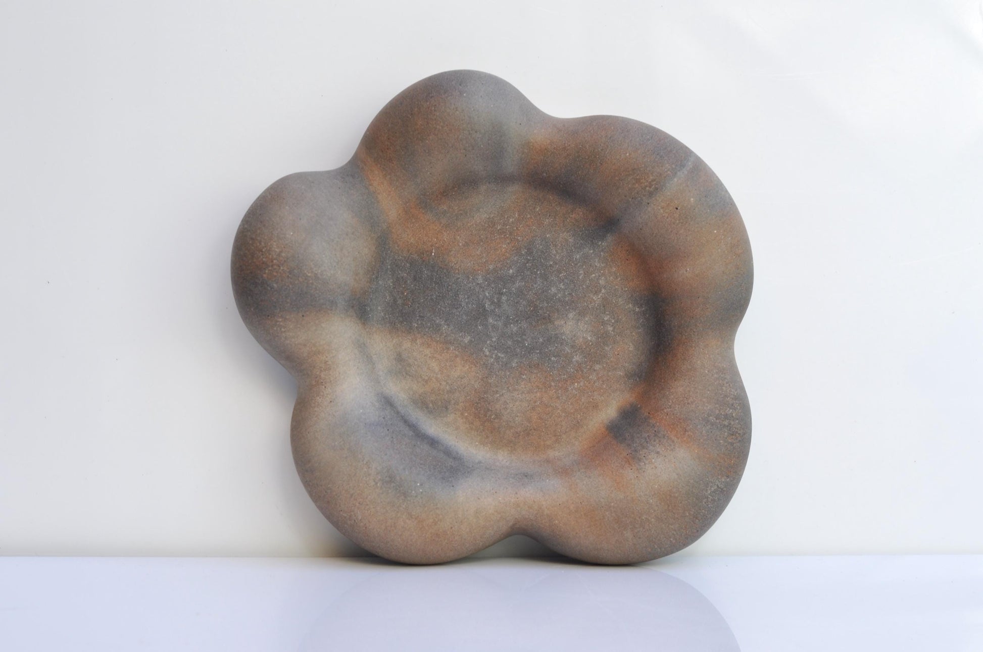 Concrete flower tray holding small home accessories