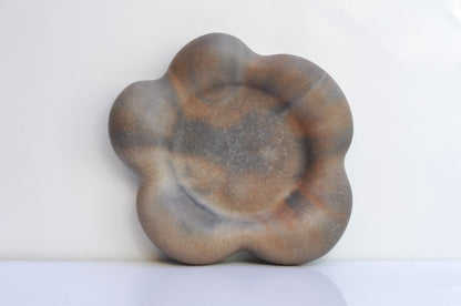 Concrete flower tray holding small home accessories