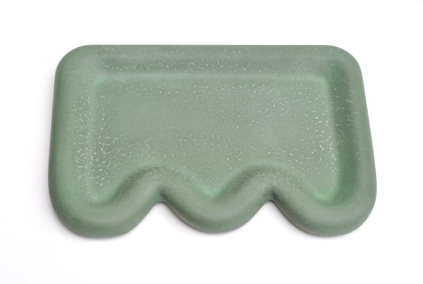 Green textured rectangular object on a white background