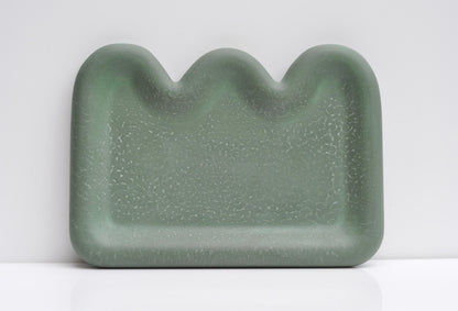 Studio photo of handmade green minimalist concrete tray