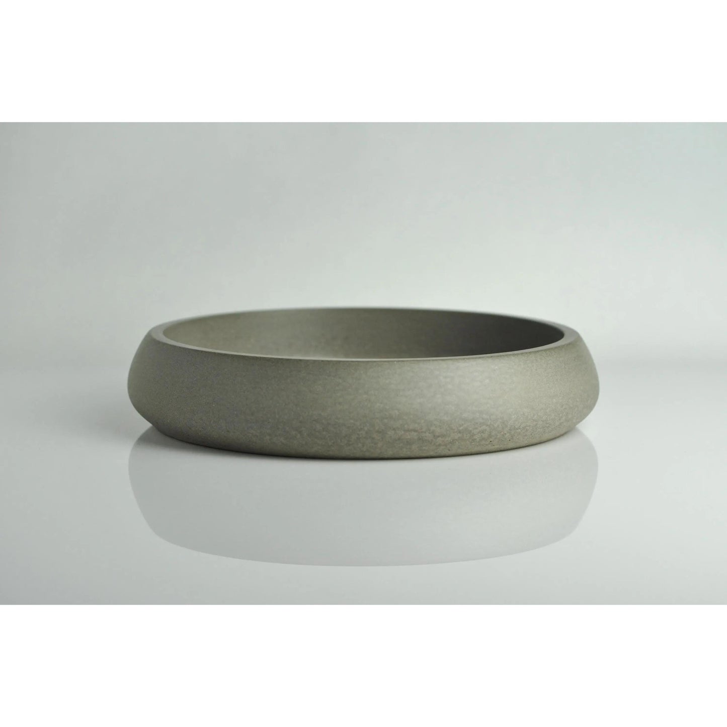 Grey concrete key bowl on entryway table