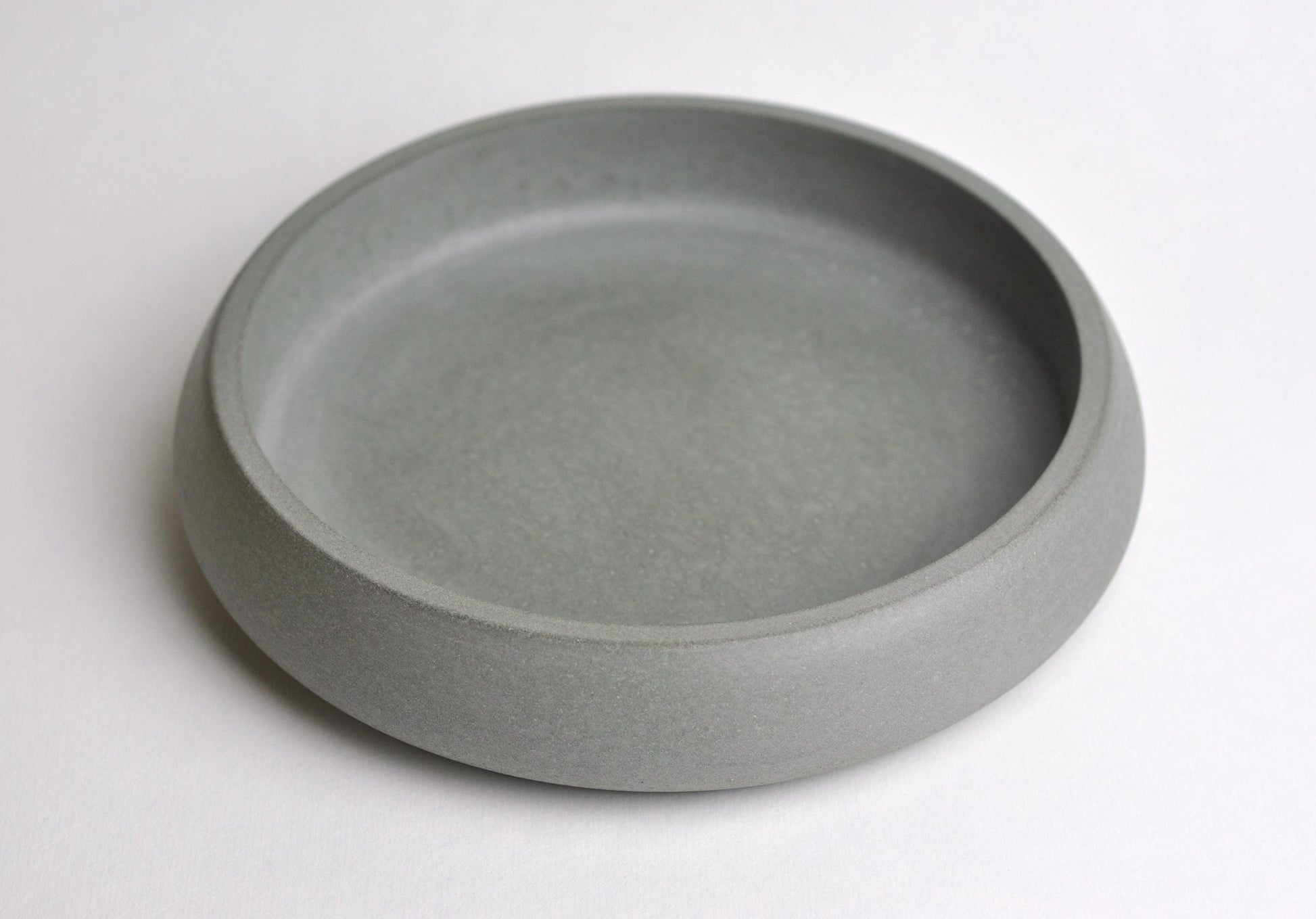 Studio shot of handmade modern grey concrete bowl