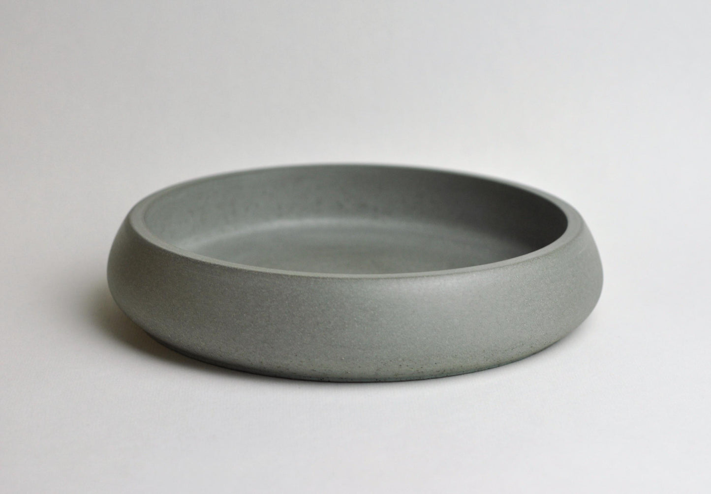 Minimalist concrete dish on shelf or desk