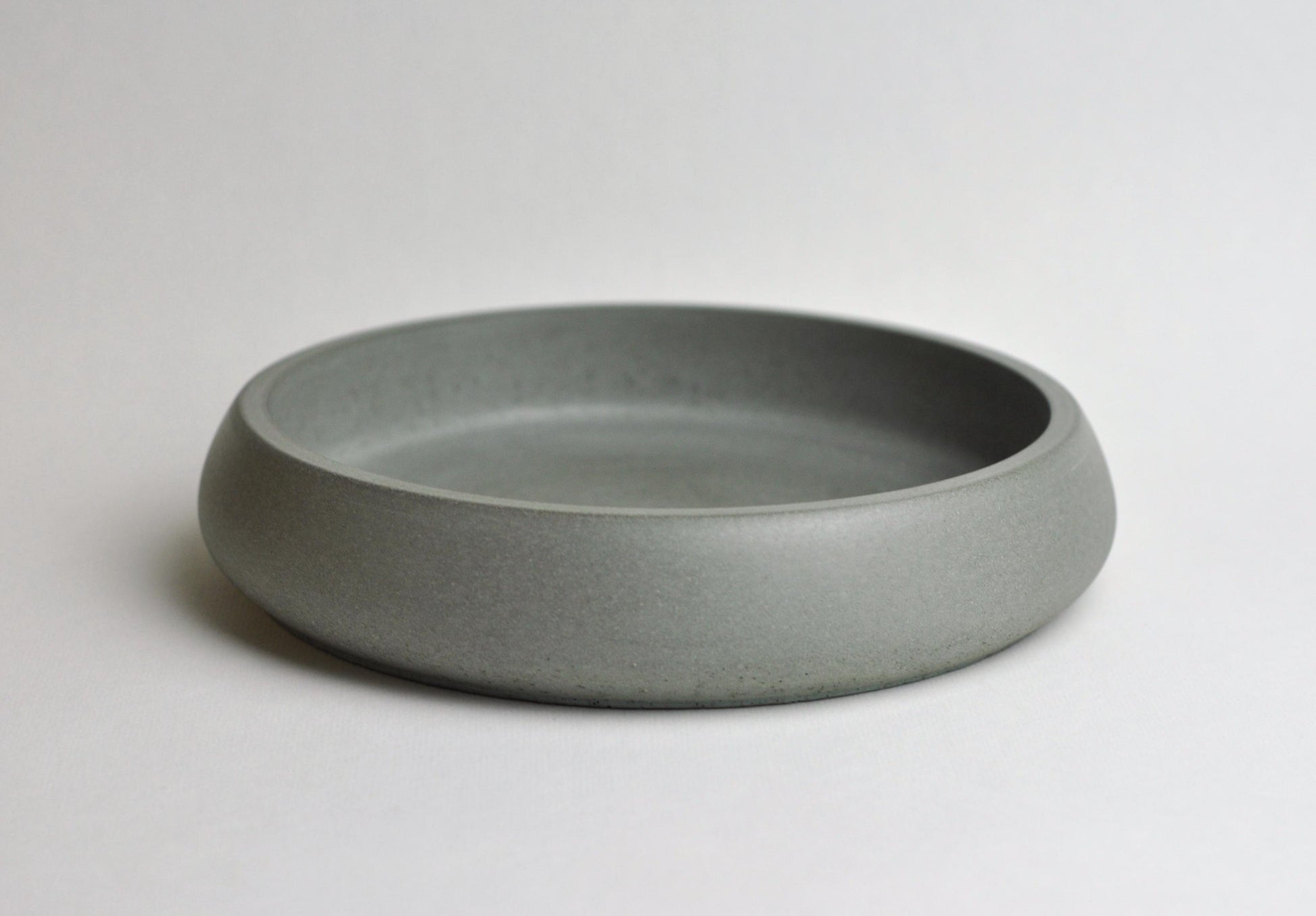 Minimalist concrete dish on shelf or desk