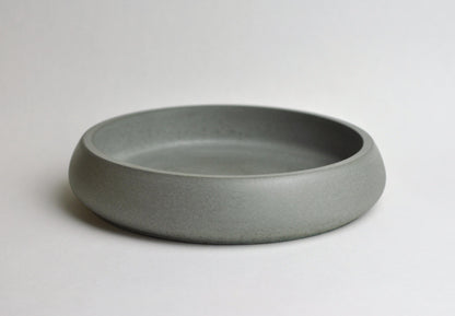 Minimalist concrete dish on shelf or desk