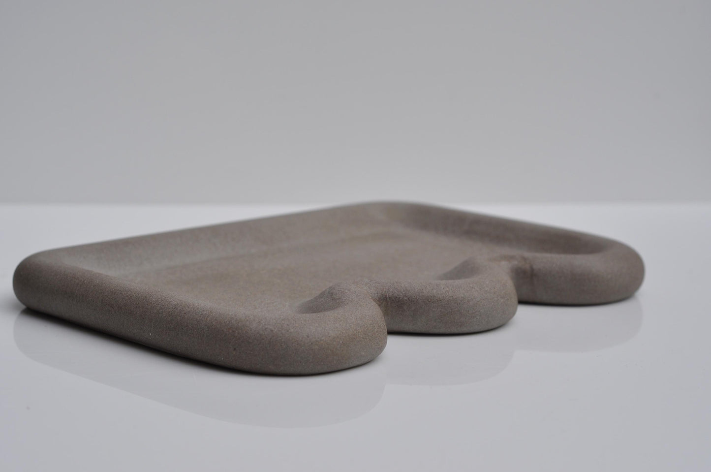 Studio shot of minimalist grey concrete vanity tray