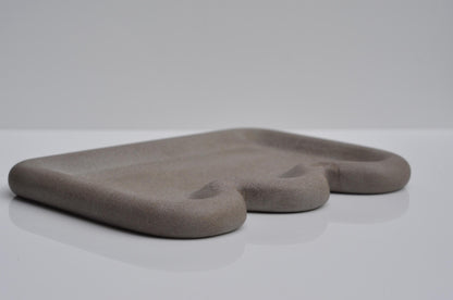 Studio shot of minimalist grey concrete vanity tray